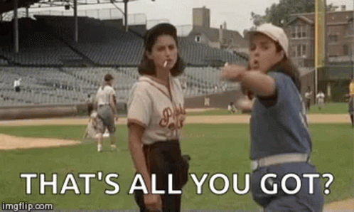Two Women Standing On Baseball Field Smoking Cigarettes GIF