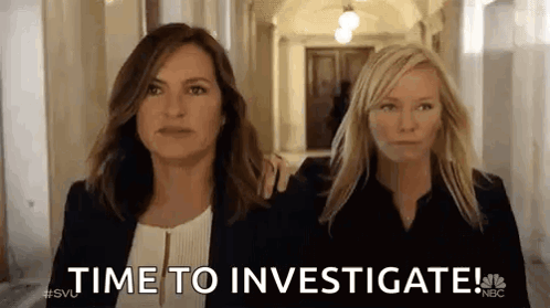Two Women Are Walking Down A Hallway And One Of Them Is Holding The Other 'S Arm . GIF