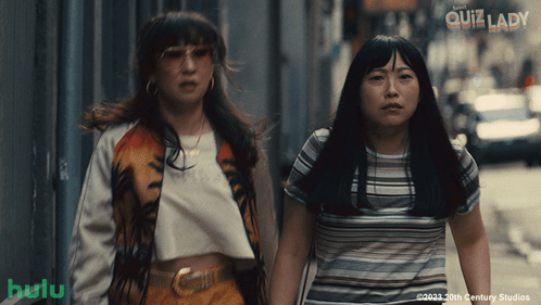 Two Women Are Walking Down A Street And The Words Quiz Lady Are On The Bottom GIF
