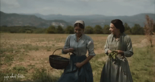 Two Women Are Walking In A Field With The Words " Gifs About Life " Written On The Bottom GIF