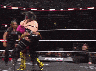 Two Women Are Wrestling In A Ring With The Word Raw On The Side GIF