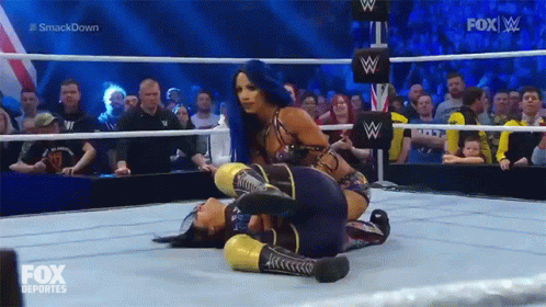 Two Women Are Wrestling In A Wrestling Ring With Fox Deportes On The Screen GIF