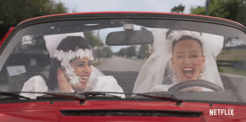 Two Women Bride And Groom Driving Red Car With Netflix GIF