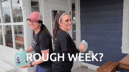Two Women Carrying Gallons of Rough Week