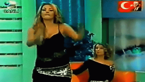 Two Women Dancing in Front of Canli Logo