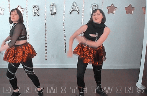 Two Women Dancing In Front Of Roar Balloons GIF
