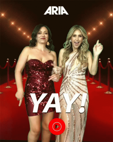 Two Women Dancing on Red Carpet Saying Yay
