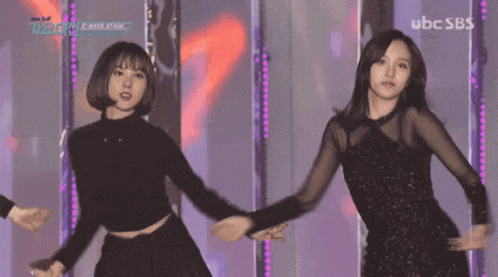 Two Women Dancing on Stage With UBC SBS
