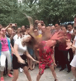 Two Women Dancing, One in Superman Shirt