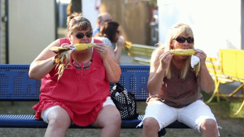 Two Women Eating Corn on the Cob