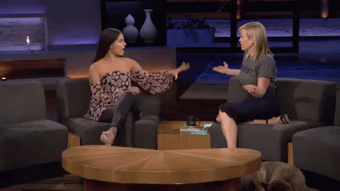 Two Women High Fiving In Resist Shirts GIF