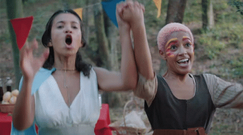 Two Women Holding Hands With Face Paint GIF