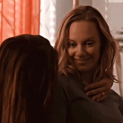 Two Women Hugging and Smiling in Mirror