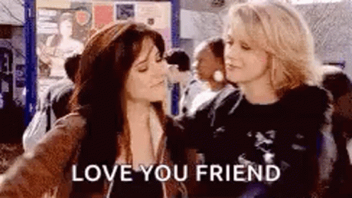 Two Women Hugging Crowded Area Love You Friend GIF