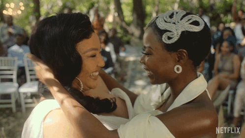 two women hugging each other with a netflix logo in the background
