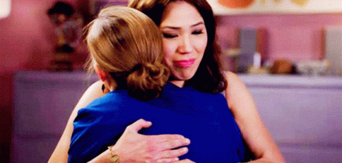 Two Women Hugging in Restaurant