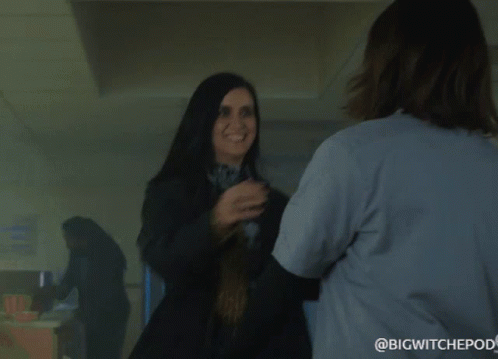 Two Women Hugging One With Jade Name Tag