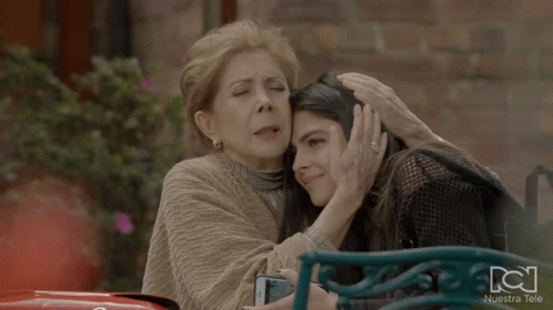 Two Women Hugging With Nuestra Tele