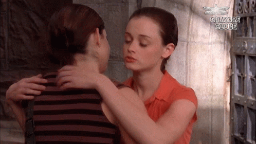 Two Women Hugging With The Words Gilmore Clube In The Corner GIF