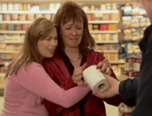 Two Women Hugging With Toilet Paper Roll