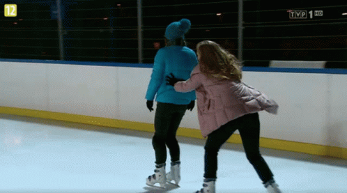 Two Women Ice Skating In Front Of TVP 1 HD GIF