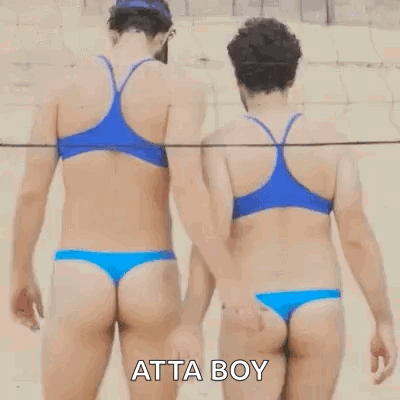 Two Women In Bikinis Are Holding Hands On A Beach . GIF
