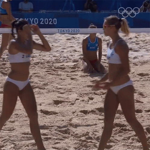 Two Women In Bikinis Are Playing Beach Volleyball In Tokyo 2020 GIF