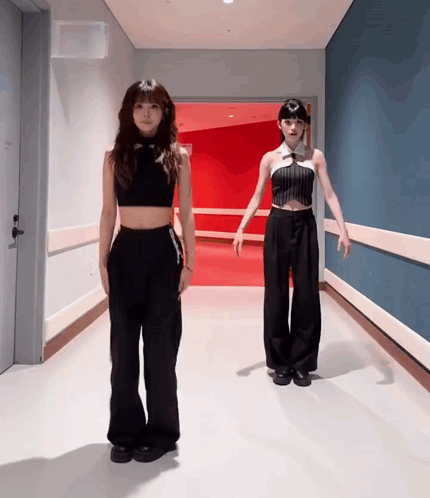 Two Women in Black in Hallway