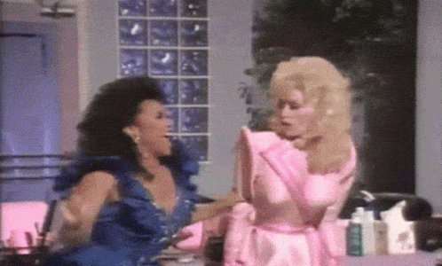 Two Women in Blue and Pink Dresses