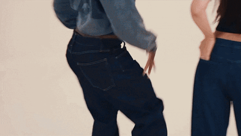 Two Women in Blue Jeans Hands in Pockets