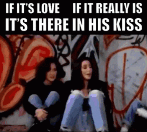 Two Women in Front of Graffiti Wall Saying If It's Love