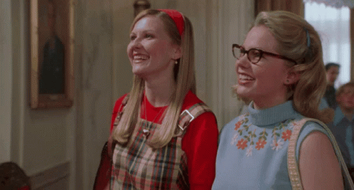 Two Women in Glasses and Plaid Dresses Smiling