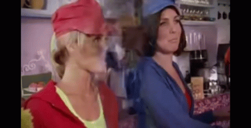 Two Women in Hats in Kitchen