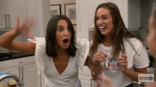 Two Women in Kitchen One Wearing Bravo Shirt