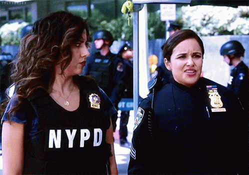 Two Women in NYPD Uniforms Standing Together