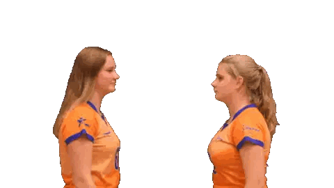 Two Women in Orange Shirts High Fiving