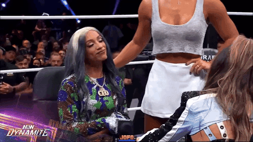 Two Women in Wrestling Ring With Dynamite Logo