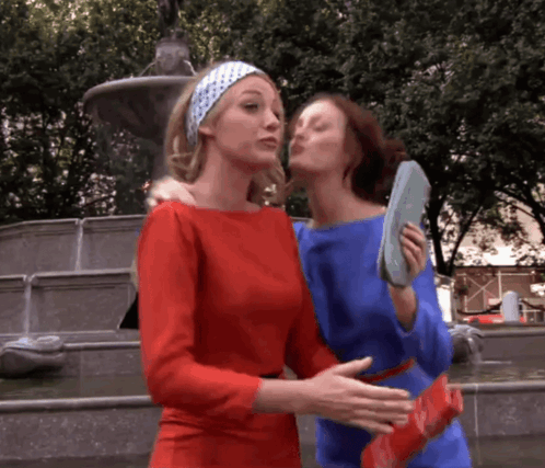 Two Women Kissing in Front of Fountain