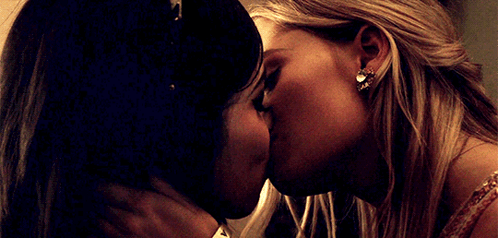 Two Women Kissing One Wearing Earrings GIF