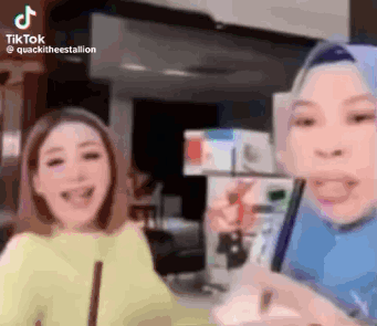 Two Women Laughing at Phone