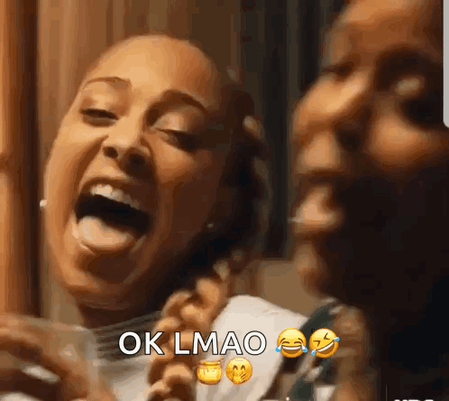 Two Women Laughing One Holding Cell Phone