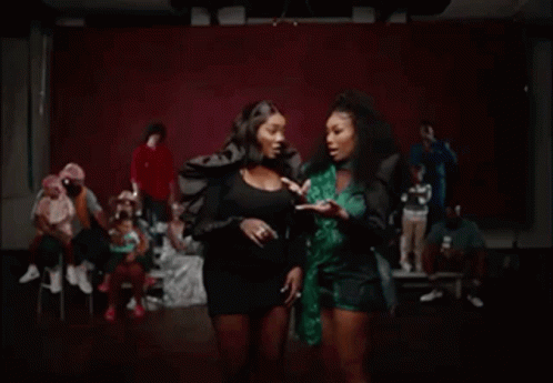 Two Women Laughing, One In Green Top GIF