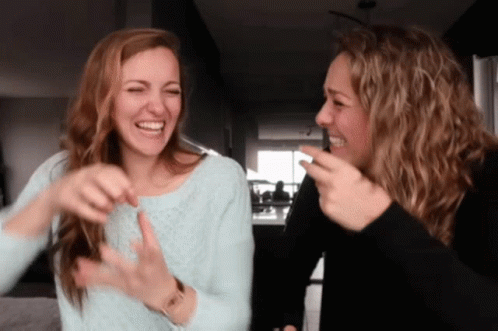 Two Women Laughing, One Wearing Watch