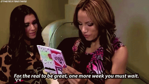 Two Women Looking at Card Saying For The Real To Be Great One More Week You Must Wait