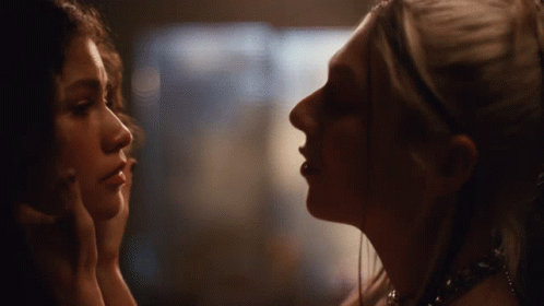 Two Women Looking at Each Other in Dark Room