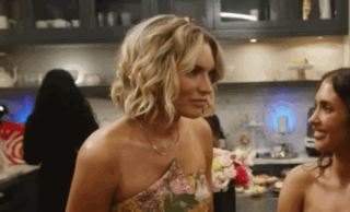 Two Women Looking at Each Other in Kitchen