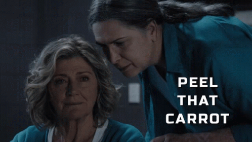 Two Women Looking at Each Other Saying Peel That Carrot