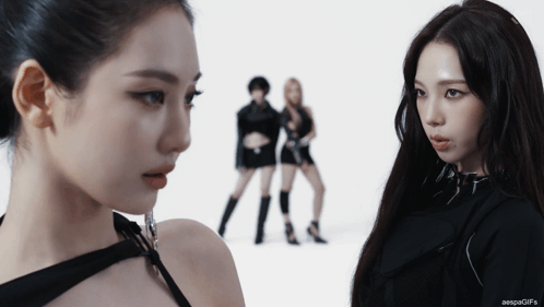 Two Women Looking At Each Other With The Words Aespagifs On The Bottom Right GIF