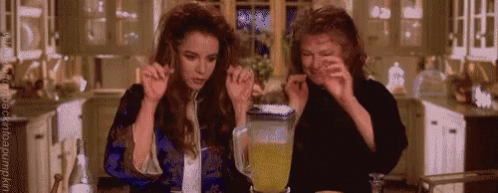 Two Women Making Drink in Kitchen