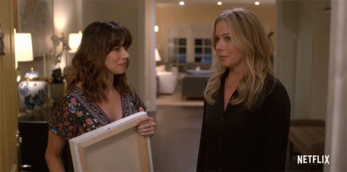 Two Women Next to Netflix Logo
